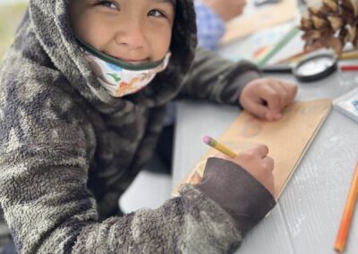 kid smiling working on a craft