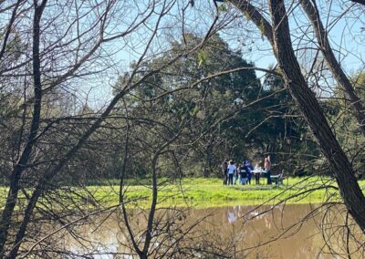 kids standing near a pond