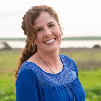 andrea smiling in field