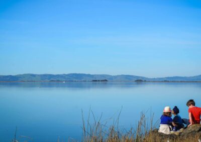 kids sitting on beach at wetlands