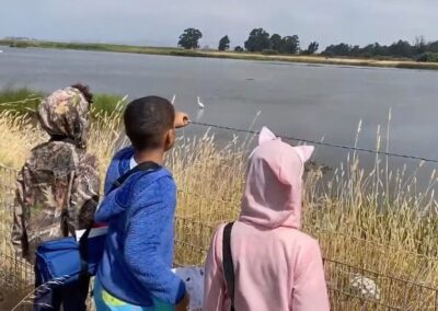 children looking at a pond