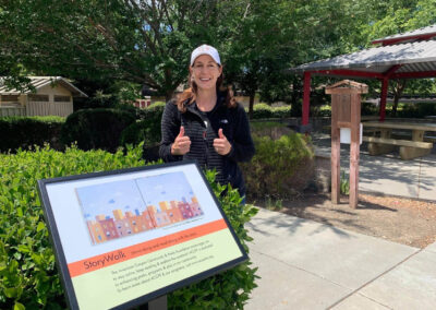ACCPF executive director giving two thumbs up for the new story walk kiosks