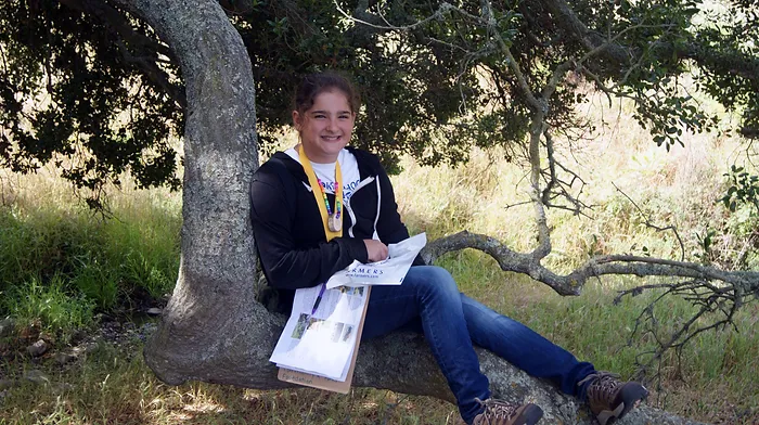 girl sitting under tree