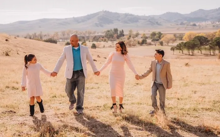 family holding hands outside