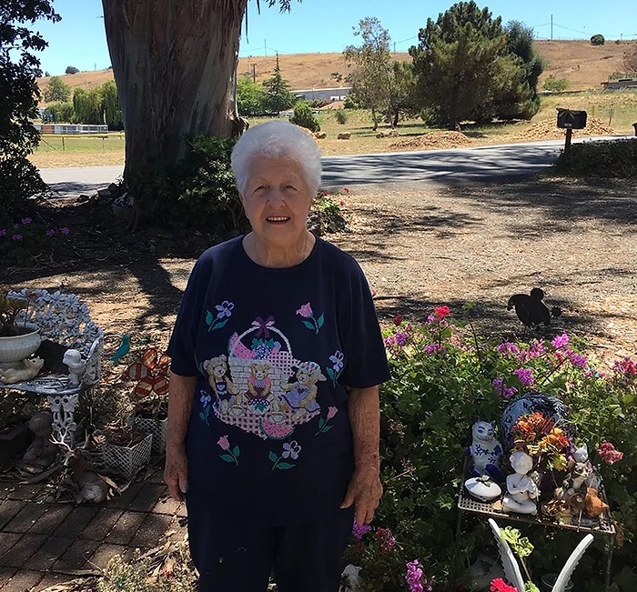 Member Fran Lemos standing outside in nature