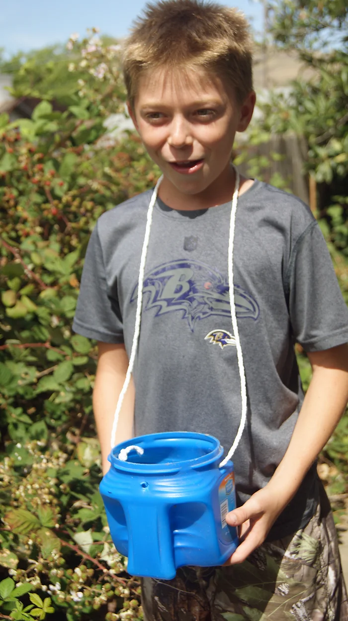 boy holding bucket of berries