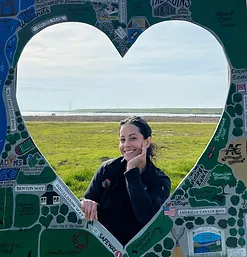 woman posing behind a heart