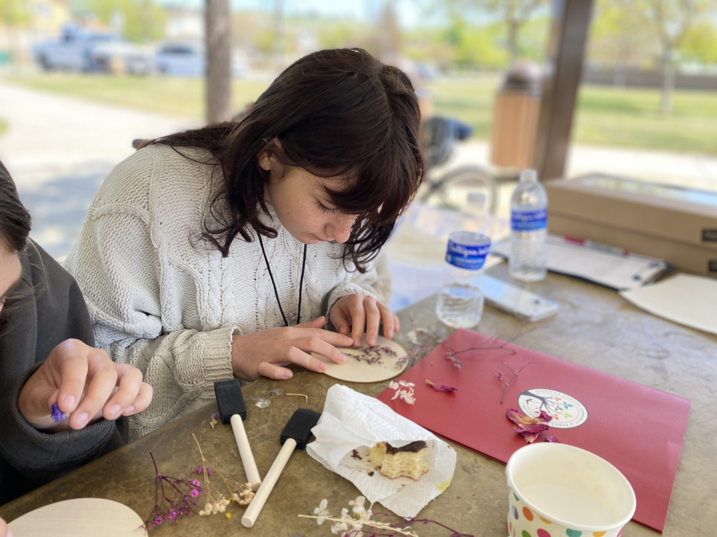 Young teen girl creating nature art