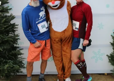 people smiling with reindeer (person in costume)