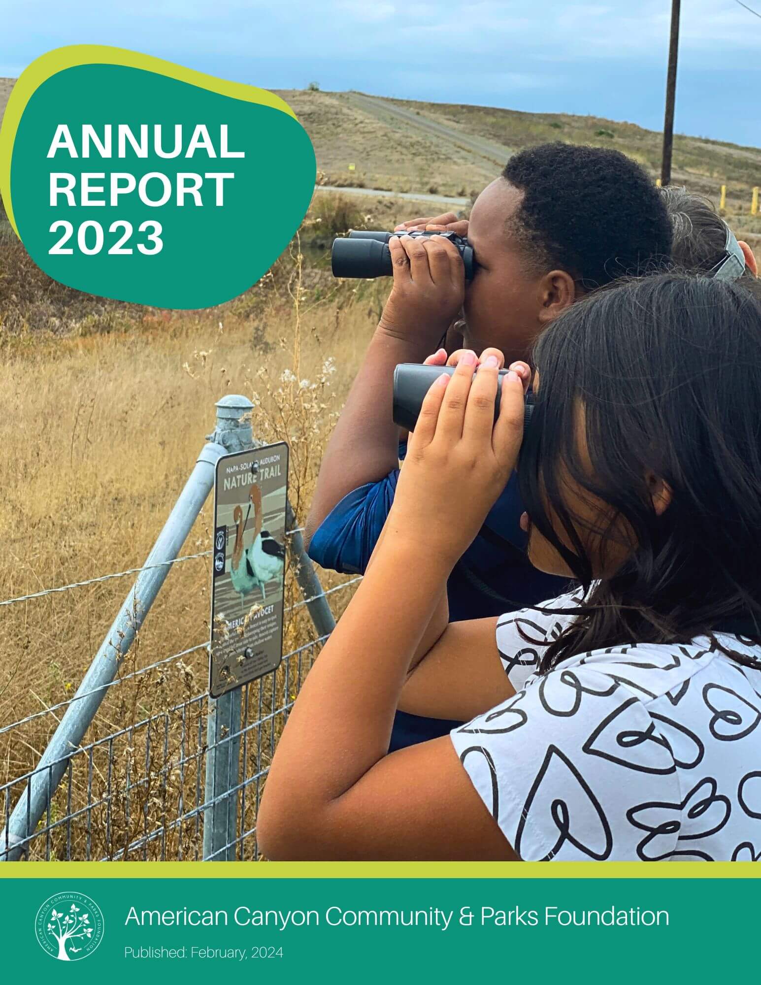 Cover of the 2023 Annual Report girl and boy looking at the wetlands through binoculars