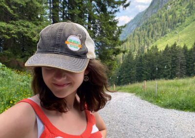 teen in mountains and 100 hours outside hat