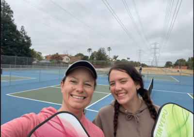 mother and daughter at tennis court