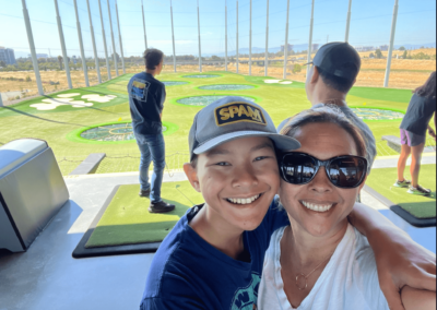 mother and son at driving range